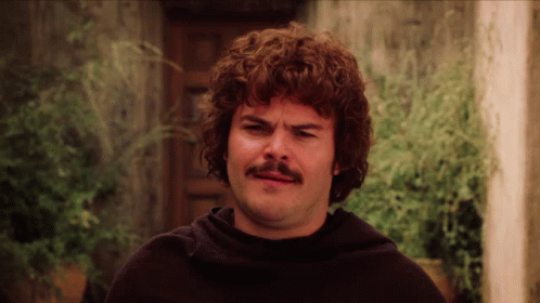 A Man With Curly Hair And A Mustache Is Wearing A Black Sweater GIF