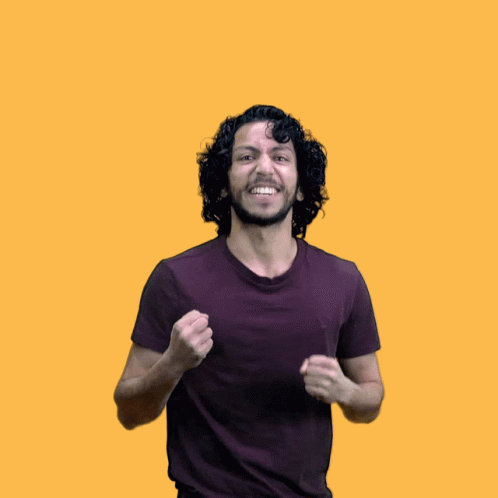 a man with curly hair and a purple shirt is raising his arms in the air