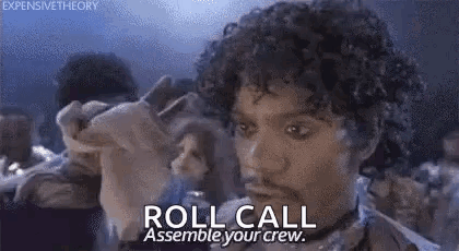 A Man With Curly Hair Is Holding A Piece Of Paper And Says `` Roll Call Assemble Your Crew . '' GIF