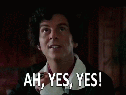 a man with curly hair is making a funny face and saying `` ah , yes , yes ! ''