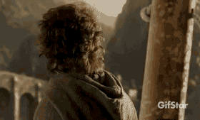 A Man With Curly Hair Is Standing In Front Of A Mountain And A Sign That Says Gifstar On It GIF