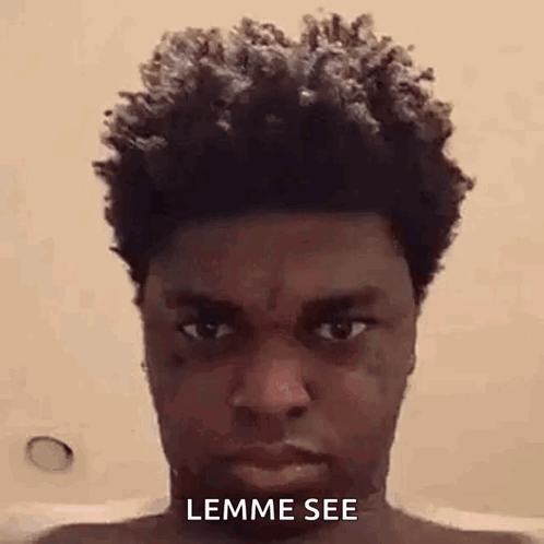 A Man With Curly Hair Is Taking A Selfie In A Bathtub . GIF