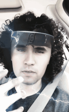 a man with curly hair is wearing a headband that says g on it
