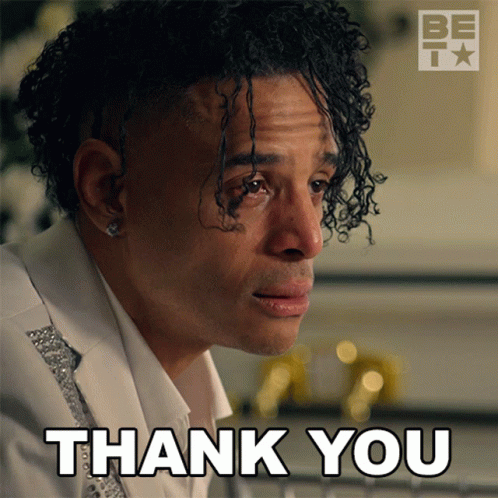 A Man With Curly Hair Says Thank You With A Be Icon In The Background GIF