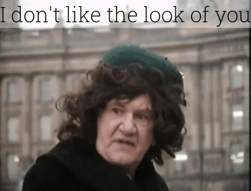 A Man With Curly Hair Wearing A Green Hat With The Words I Don 'T Like The Look Of You Above Him GIF