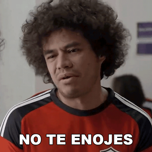 A Man With Curly Hair Wearing A Red Shirt That Says " No Te Enojes " GIF
