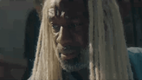 A Man With Dreadlocks And A Beard Is Crying And Looking At The Camera . GIF