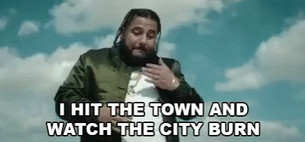 A Man With Dreadlocks And A Beard Is Standing In Front Of A Blue Sky With Clouds . GIF