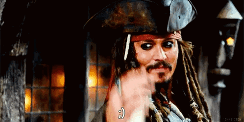 A Man With Dreadlocks And A Beard Is Wearing A Pirate Hat And Pointing At Something . GIF
