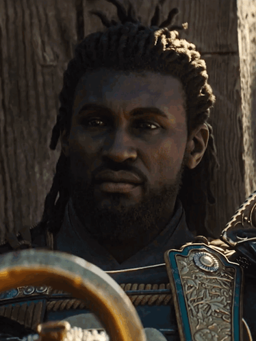 A Man With Dreadlocks And A Beard Is Wearing Armor GIF