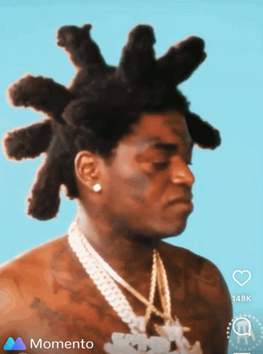 A Man With Dreadlocks And A Chain Around His Neck Is On A Momento Screen GIF
