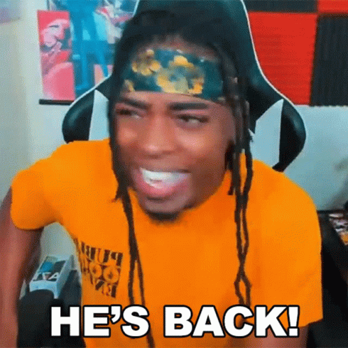 A Man With Dreadlocks And A Headband Is Smiling And Saying He 'S Back GIF