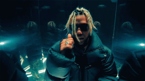 A Man With Dreadlocks And A Ring On His Finger Giving A Thumbs Up GIF