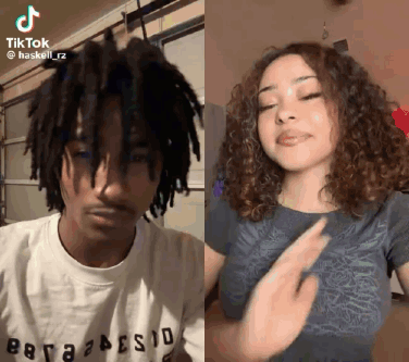 A Man With Dreadlocks And A Woman With Curly Hair Are Dancing Together On Tiktok . GIF