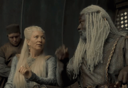 A Man With Dreadlocks And A Woman With Long White Hair GIF