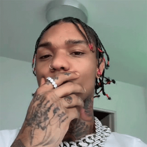 A Man With Dreadlocks Has A Ring In His Nose GIF