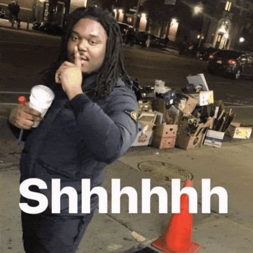A Man With Dreadlocks Holds His Finger To His Mouth And Says " Shhhh " GIF