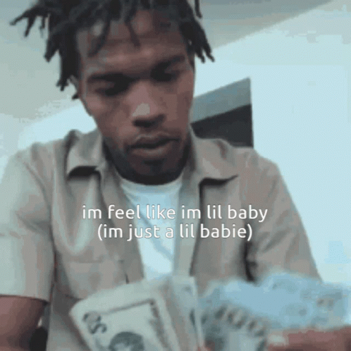 A Man With Dreadlocks Is Holding A Bunch Of Money And Says Im Feel Like Im Lil Baby GIF