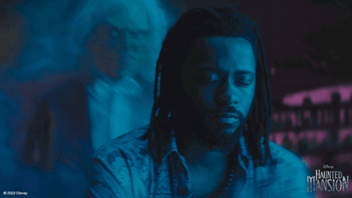 A Man With Dreadlocks Is In A Haunted Mansion Advertisement GIF