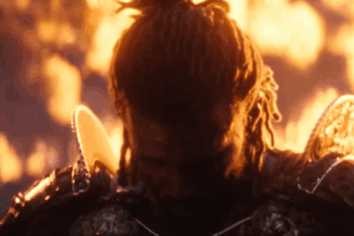 A Man With Dreadlocks Is Standing In Front Of A Flame GIF