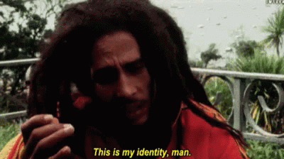 A Man With Dreadlocks Is Talking On A Cell Phone And Says " This Is My Identity Man " GIF