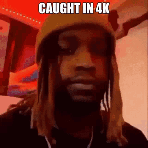 A Man With Dreadlocks Is Wearing A Beanie And Headphones . GIF