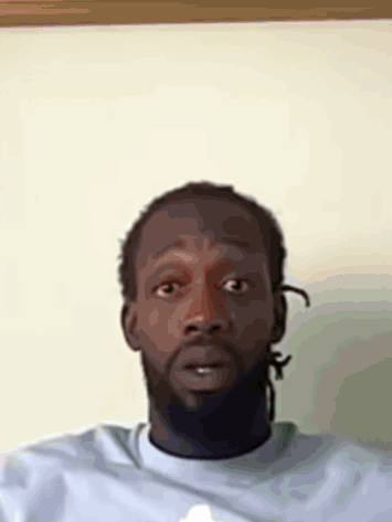 A Man With Dreadlocks Is Wearing A Blue Shirt GIF