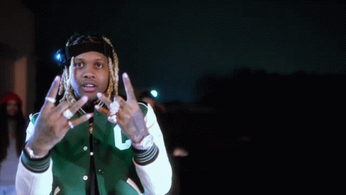 A Man With Dreadlocks Is Wearing A Green And White Jacket With The Letter C On It GIF