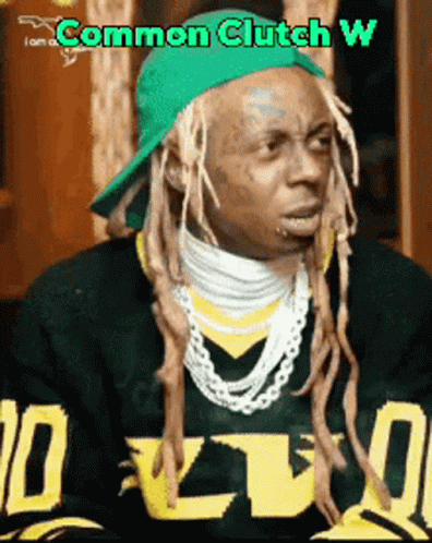 A Man With Dreadlocks Is Wearing A Green Hat And A Sweater That Says I Am A Common Clutch W. GIF