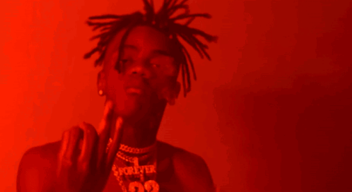 A Man With Dreadlocks Is Wearing A Necklace With The Number 99 GIF