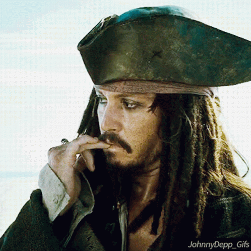 A Man With Dreadlocks Is Wearing A Pirate Hat And Smoking A Cigar GIF