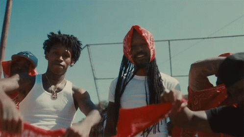 A Man With Dreadlocks Is Wearing A Red Bandana GIF