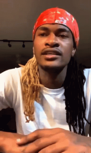 A Man With Dreadlocks Is Wearing A Red Headband GIF