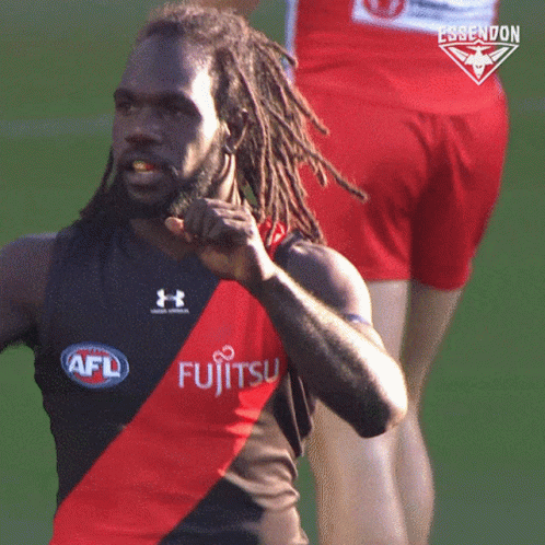 A Man With Dreadlocks Is Wearing A Shirt That Says Fujitsu On It GIF