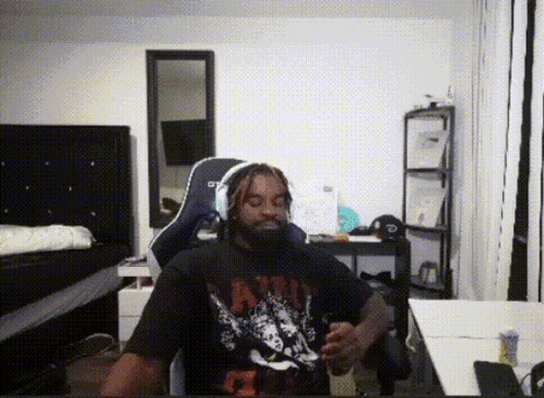 A Man With Dreadlocks Is Wearing A Shirt That Says ' Nirvana ' GIF