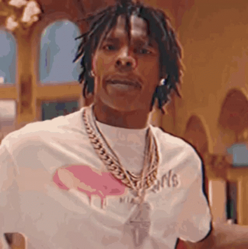 A Man With Dreadlocks Is Wearing A White Shirt And A Gold Chain . GIF