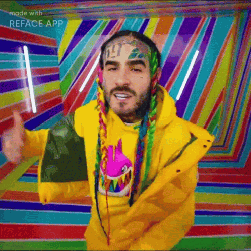 A Man With Dreadlocks Is Wearing A Yellow Jacket And Giving A Thumbs Up GIF