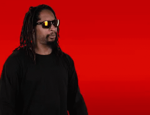 A Man With Dreadlocks Is Wearing Sunglasses And Making A Face GIF