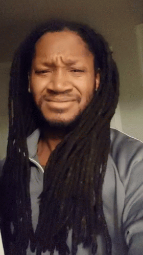 A Man With Dreadlocks Making A Sad Face GIF