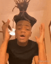A Man With Dreadlocks On His Head Is Making A Funny Face With His Hands In The Air . GIF