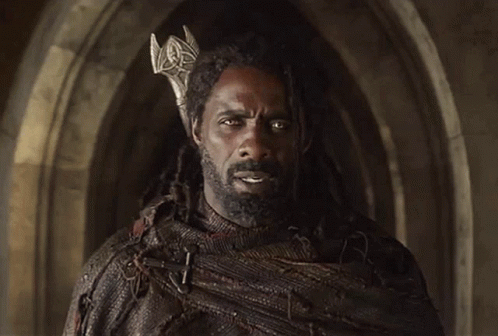 A Man With Dreadlocks Wearing A Crown On His Head GIF