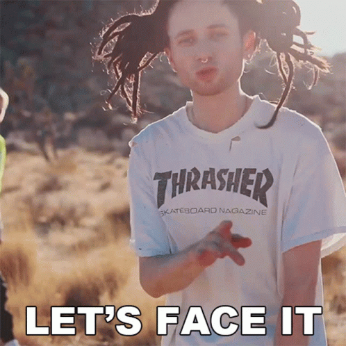 A Man With Dreadlocks Wearing A Thrasher Shirt GIF
