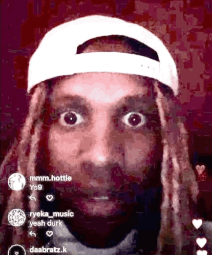 A Man With Dreadlocks Wearing A White Baseball Cap GIF