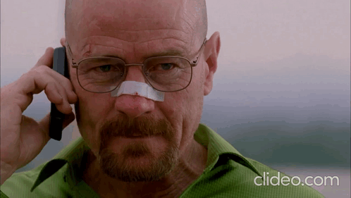 A Man With Glasses And A Bandage On His Nose Talks On A Cell Phone GIF