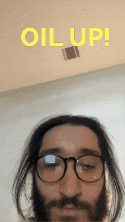 A Man With Glasses And A Beard Has The Words " Oil Up " Above Him GIF