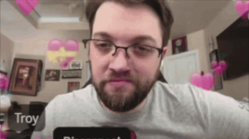 A Man With Glasses And A Beard Has Troy Written On His Phone Screen GIF