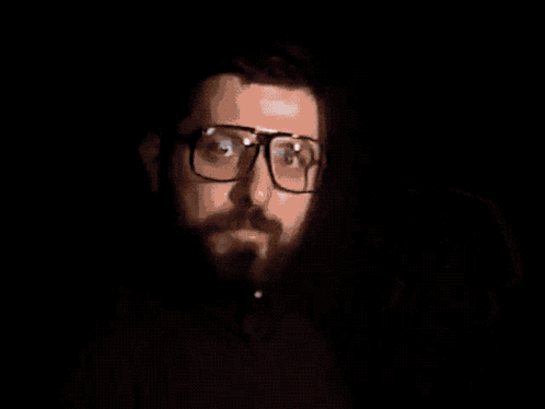 A Man With Glasses And A Beard Holding A Video Game Controller With The Words Time For Video Games Below Him GIF