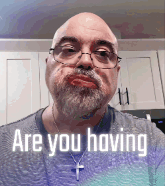 A Man With Glasses And A Beard Is Asking If He Is Having GIF