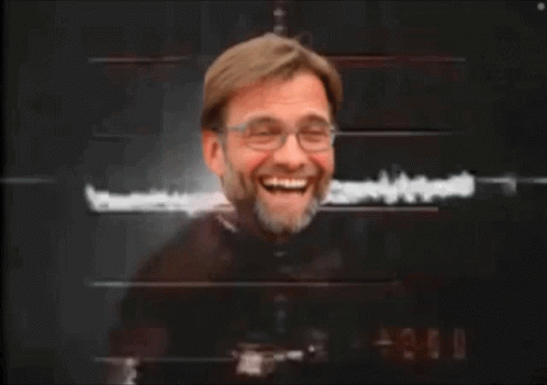 A Man With Glasses And A Beard Is Laughing GIF