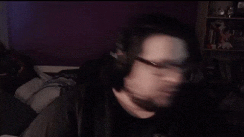 A Man With Glasses And A Beard Is Making A Face GIF